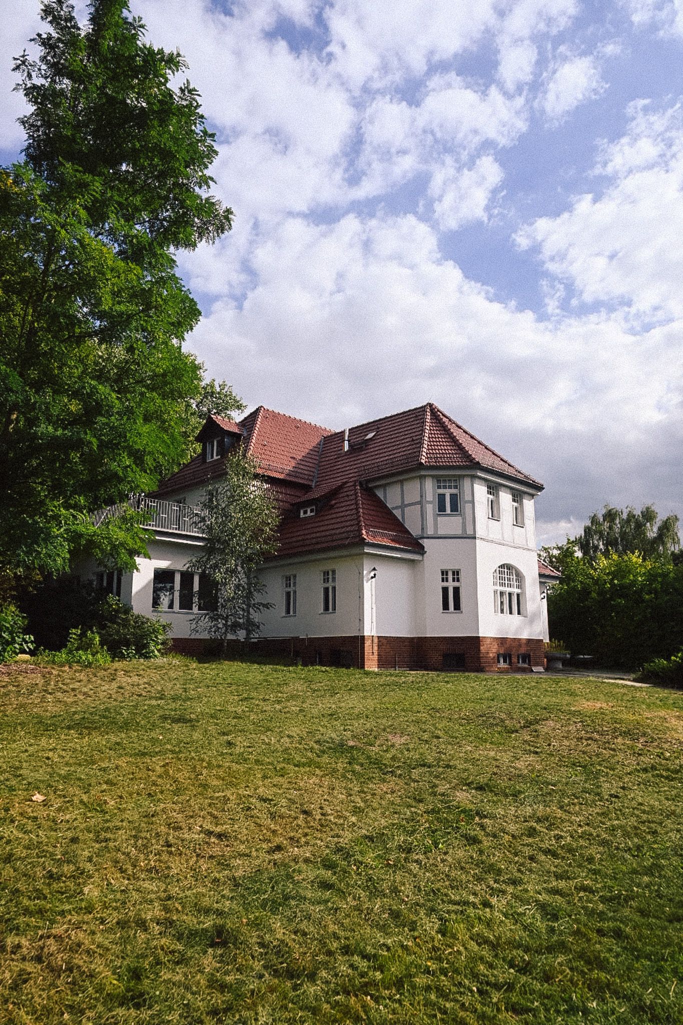The Neupitz villa beyond the large meadow on the 2-hectare lakeside property