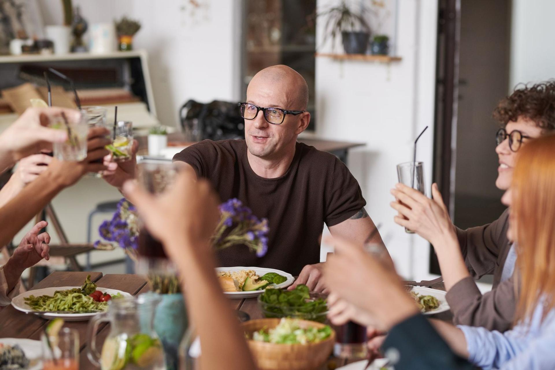 Group of friends toasting drinks at a restaurant table