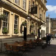 Garrick's Head in Bath: Front view with an inviting outdoor seating area, where patrons enjoy the charming ambiance of this historic pub