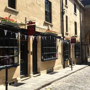 Canary Gin Bar in Bath: Charming front view with a glimpse of the cobbled stone street, offering a sophisticated gin experience