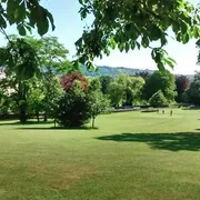Approach Golf Course in Bath: View from the fairway looking at a green with three golfers on it
