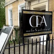 Opa in Bath: View of the signage, inviting guests to indulge in Greek flavours and enjoy the lively atmosphere of this charming restaurant