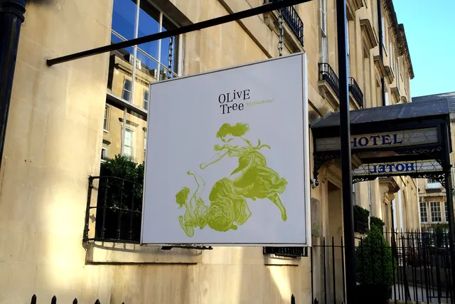 Olive Tree in Bath: Captivating hanging sign, signaling a renowned restaurant known for its exquisite cuisine and inviting dining experience