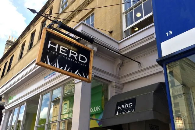 The Herd in Bath: View of the hanging sign, signaling a renowned steakhouse known for its quality cuts and inviting dining experience