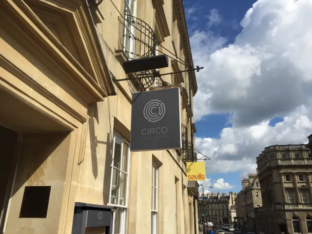 Circo in Bath: Striking entrance signage hanging above, signaling a lively bar experience with a vibrant atmosphere and exciting entertainment