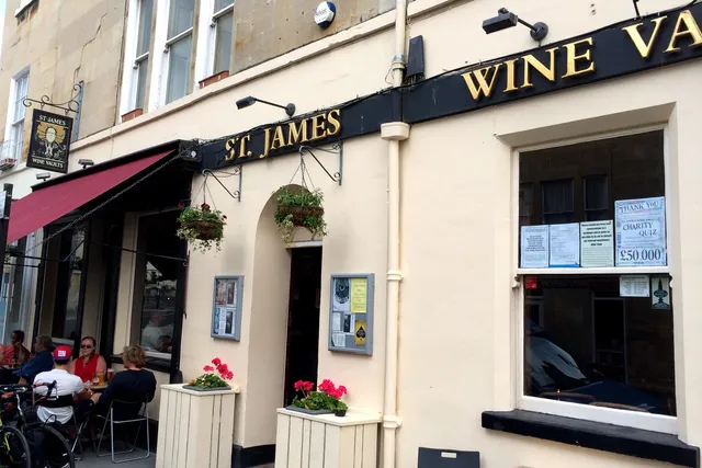 St James Wine Vault in Bath: Front view with patrons enjoying outdoor seating, adding to the relaxed and convivial atmosphere of this charming wine bar