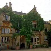 Priory in Bath: Front view adorned with climbing plants, creating a charming and inviting ambiance at this historic establishment