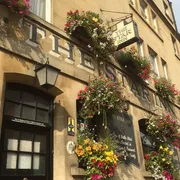The Star in Bath: Front view featuring charming hanging plants, enhancing the inviting atmosphere of this cozy and popular pub