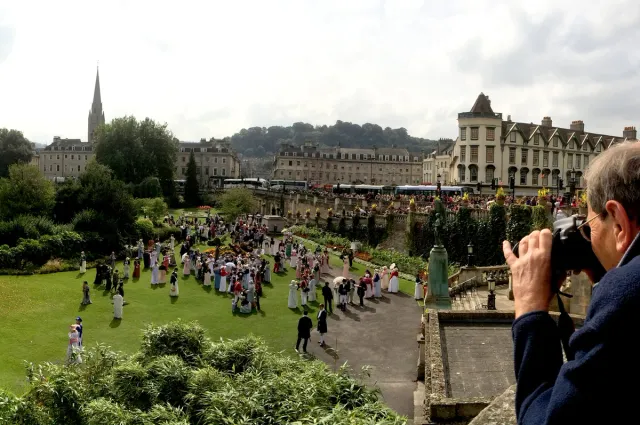 Partakers of Jane Austen festival in Parade Gardens with an onlooker taking photo