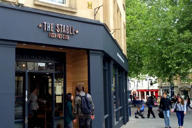The Stable in Bath: Front view with customers engaged in reading the menu, as they anticipate the delectable offerings of this popular eatery