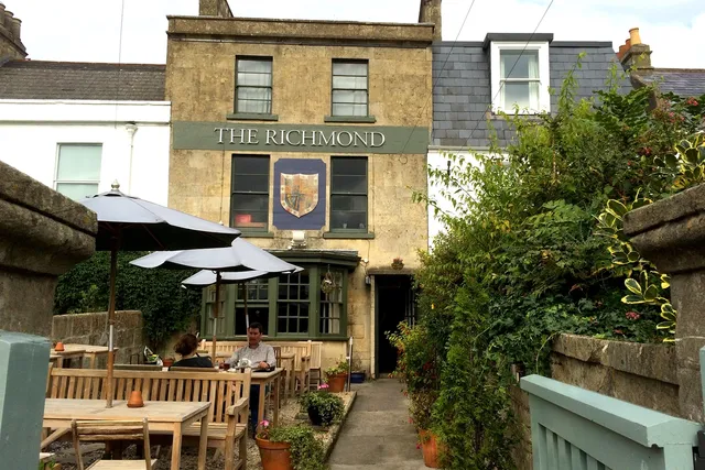 The Richmond in Bath: Front view with inviting outdoor seating area, where patrons enjoy the charming ambiance and delectable offerings of this popular establishment