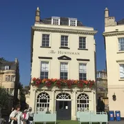 The Huntsman in Bath: Charming front view of a cozy pub, exuding a warm ambiance and offering a selection of delightful drinks