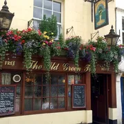 The Old Green Tree in Bath: Entrance view with charming hanging plants, adding a touch of nature to this traditional pub's inviting ambiance