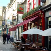 Coeur De Lion in Bath: Inviting front view with people strolling down Northumberland Passage, adding a charming ambiance to a traditional setting
