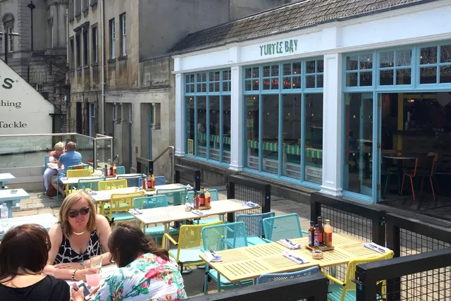 Turtle Bay in Bath: Front view with patrons in their outdoor seating area, enjoying the Caribbean flavours