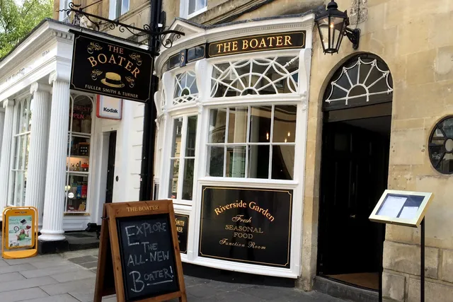 The Boater in Bath: Quaint front view of a riverside pub, featuring outdoor seating and a charming, relaxed ambiance