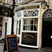 The Boater in Bath: Quaint front view of a riverside pub, featuring outdoor seating and a charming, relaxed ambiance