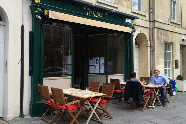The Circus Restaurant in Bath: Captivating front view with two patrons enjoying the outdoor area, offering a delightful dining experience