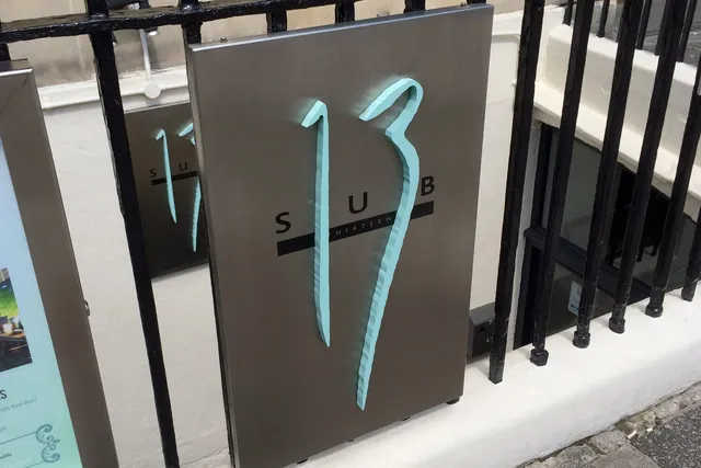 Sub 13 in Bath: Eye-catching front signage, drawing attention to this trendy bar known for its creative cocktails and lively ambiance