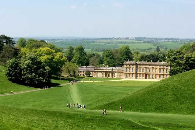 Dyrham Park house, visitors approaching and lush green surroundings