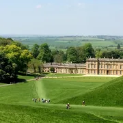 Dyrham Park house, visitors approaching and lush green surroundings