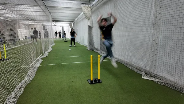 A bowler running in down an indoor lane at the Performance Centre