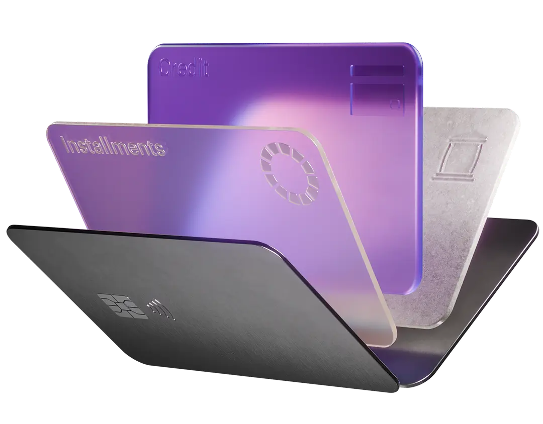 A fanned stack of four financial cards: a black card, a purple 'Installments' card, a purple 'Credit' card, and a silver card.