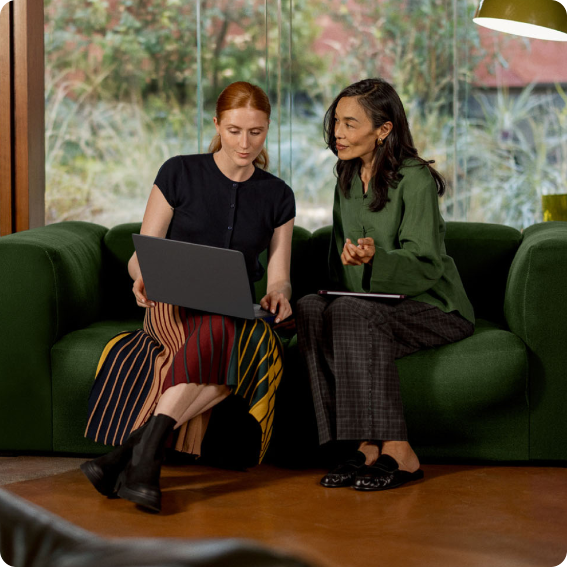 Two individuals co-working in a shared office setting.