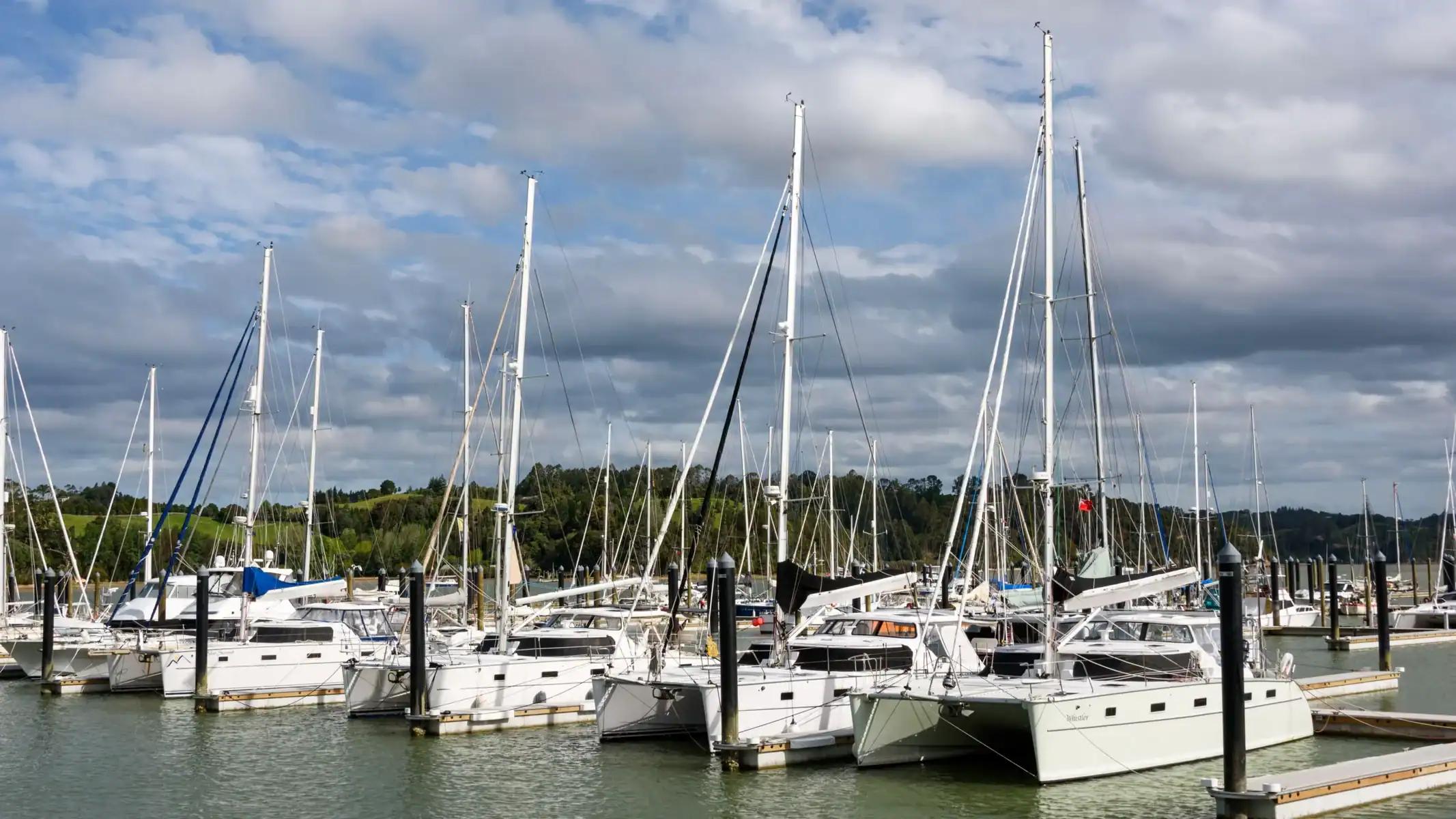 Four Antares catamarans gathered at a marina in New Zealand