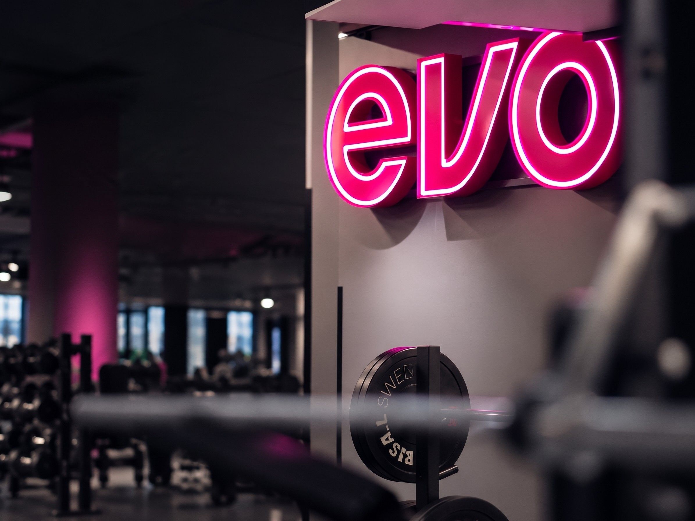 Evo neon sign above a gym floor