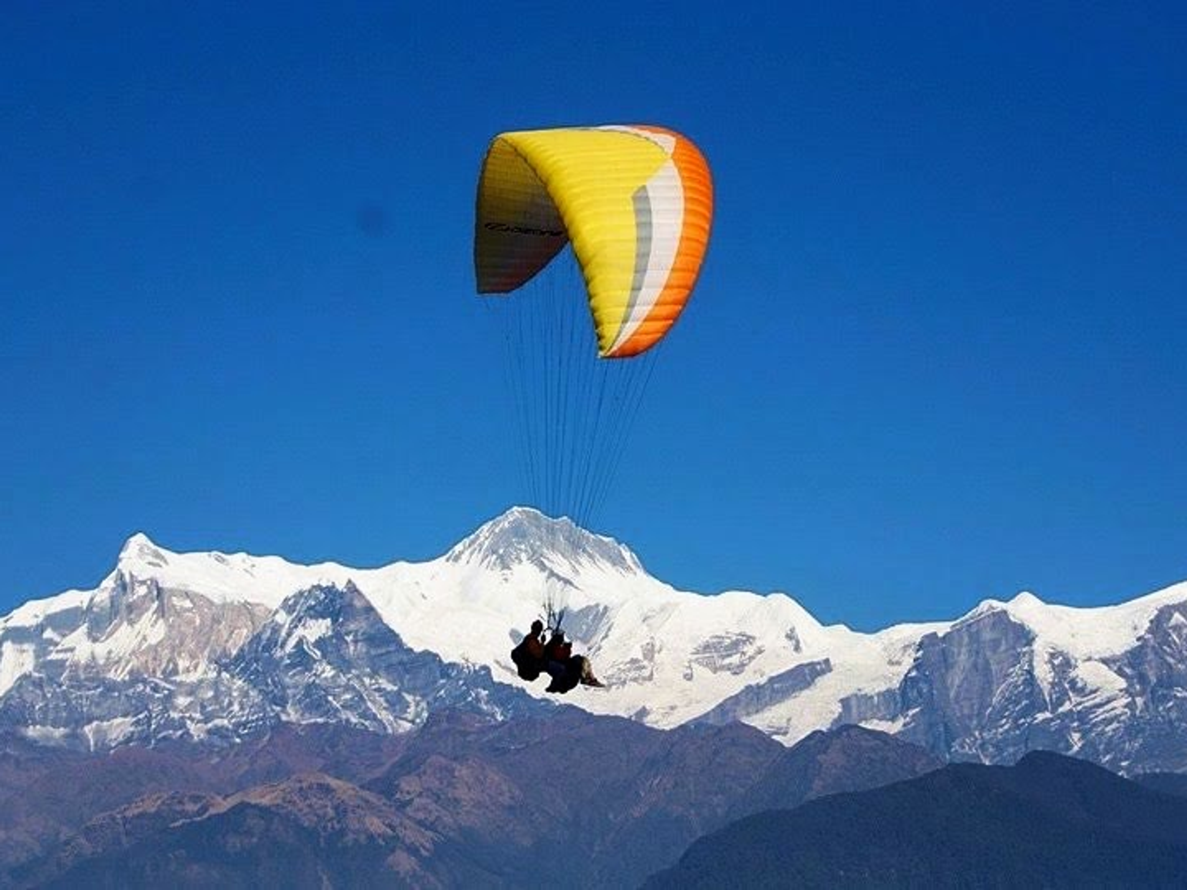 Tandem paragliding. Annapurna in the background.