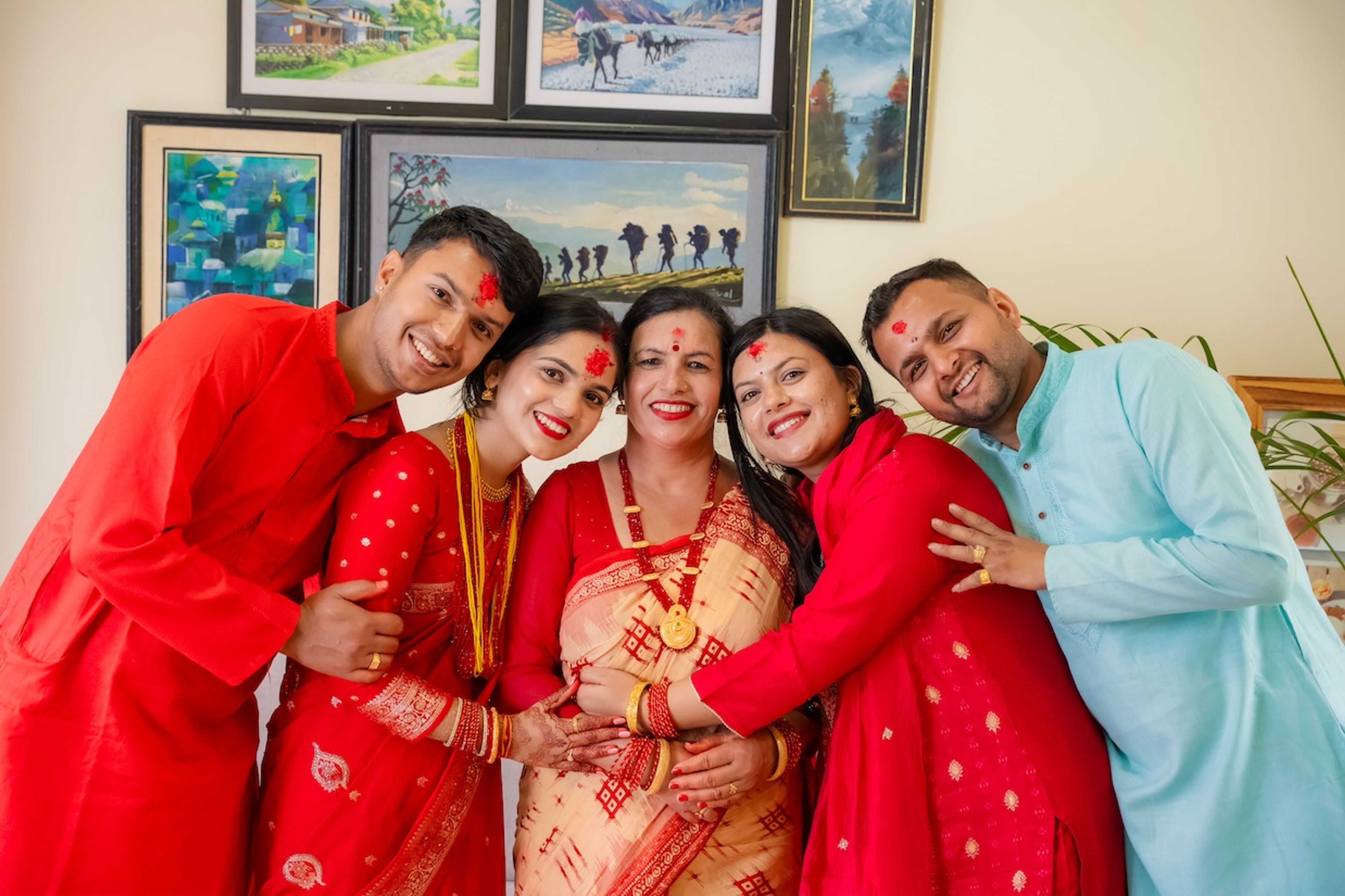 Maya with her family, all dressed in festive red and smiling together