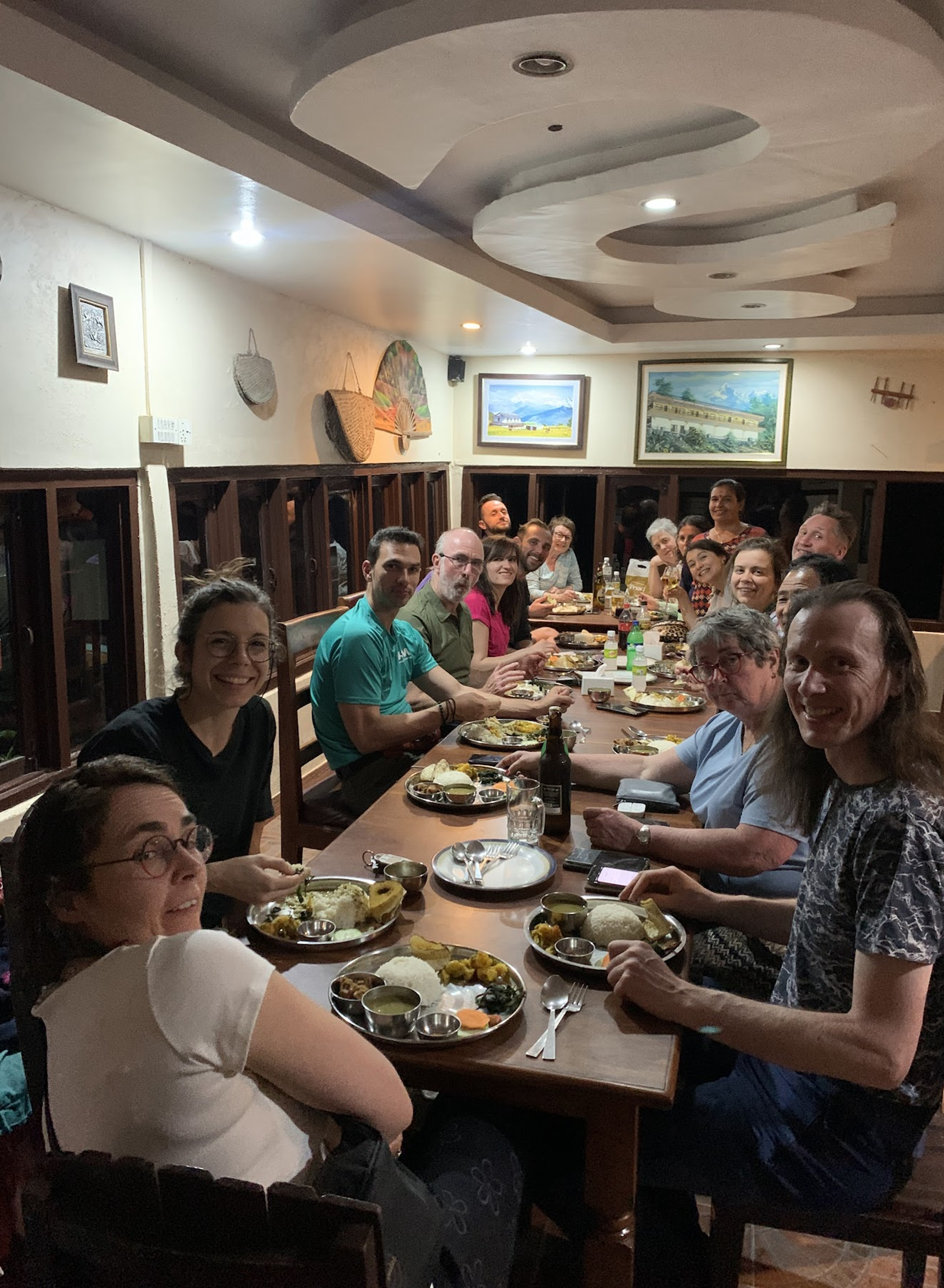 Guests having dinner together at a long table