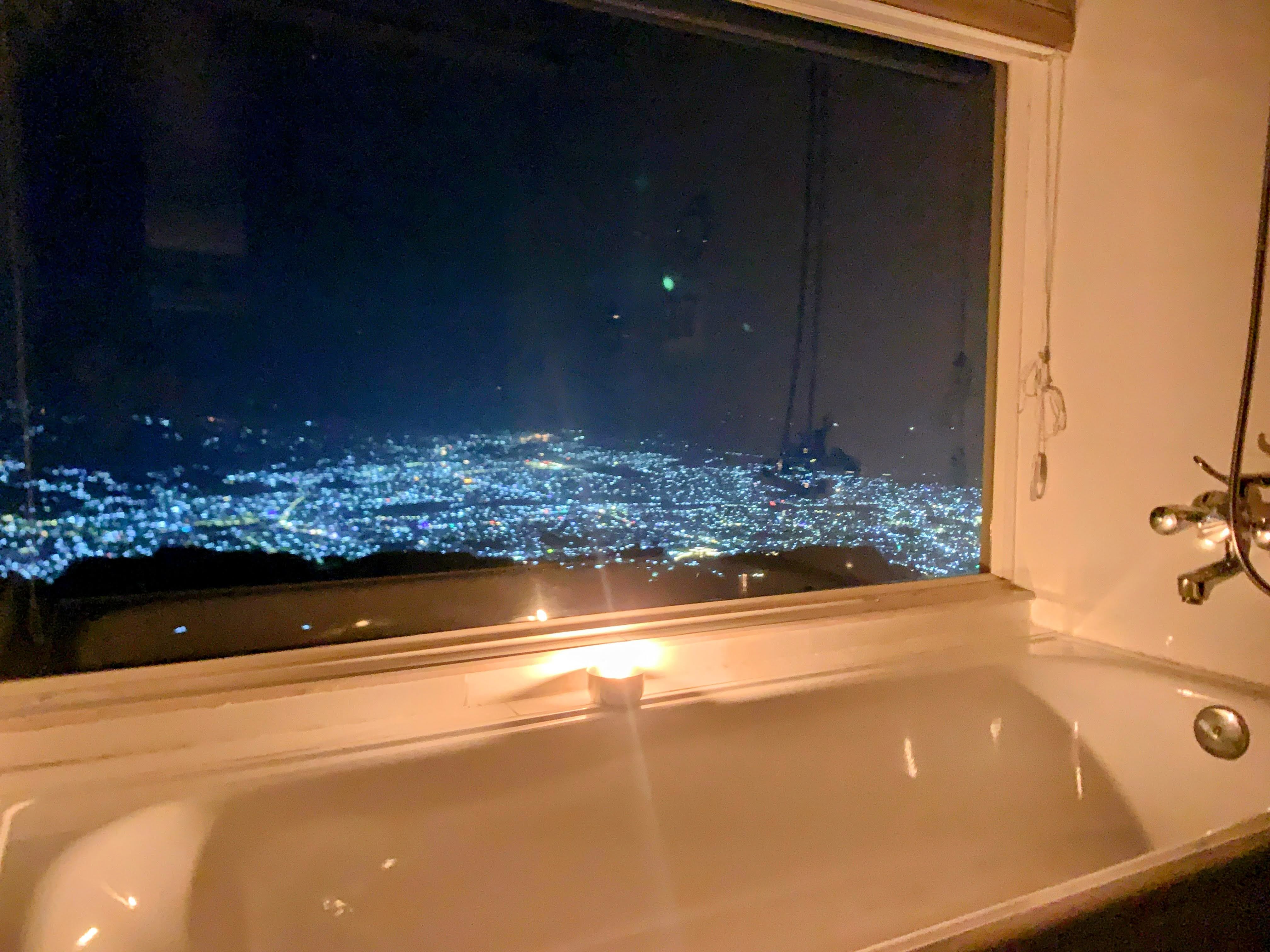 The lights of Pokhara at night from the Junior suite's bathtub