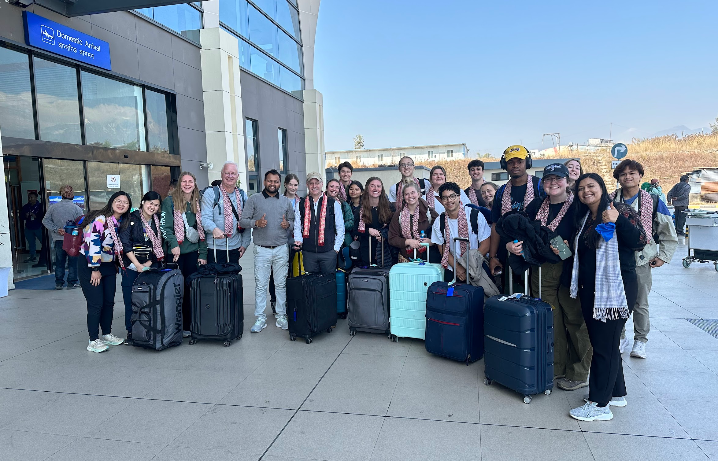 A group of students being welcomed at the airport