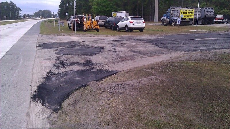 Parking lot repavement before photo: the original parking lot surface before it was repaved