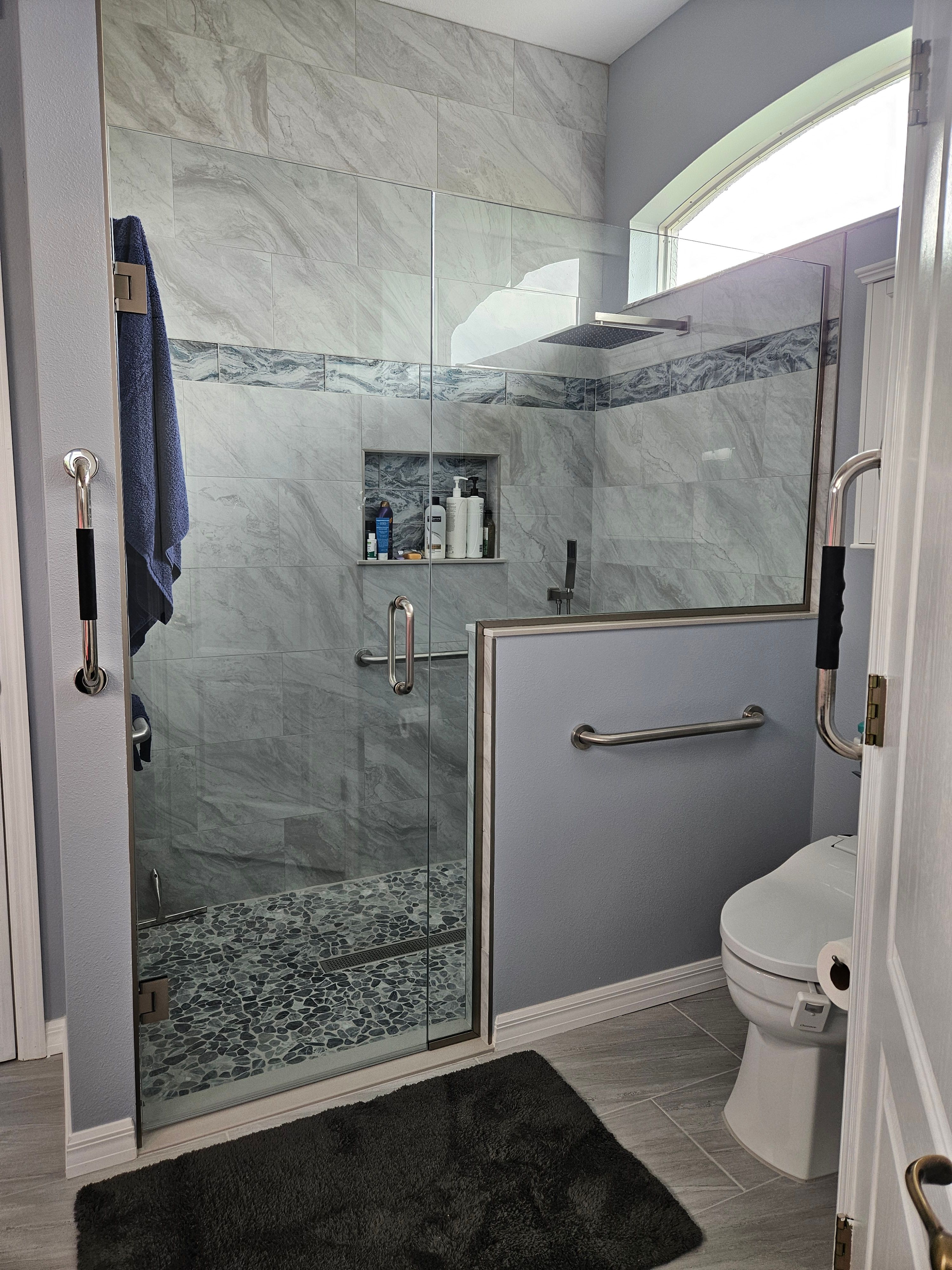 New ADA compliant bathroom with grab bars and custom shower glass door.