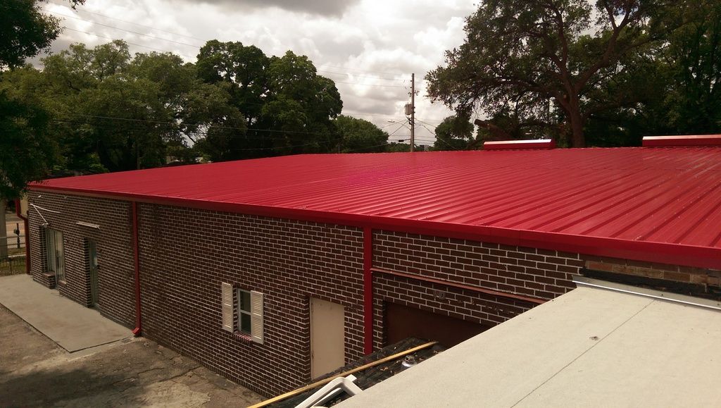Finished red metal roof section after installation.