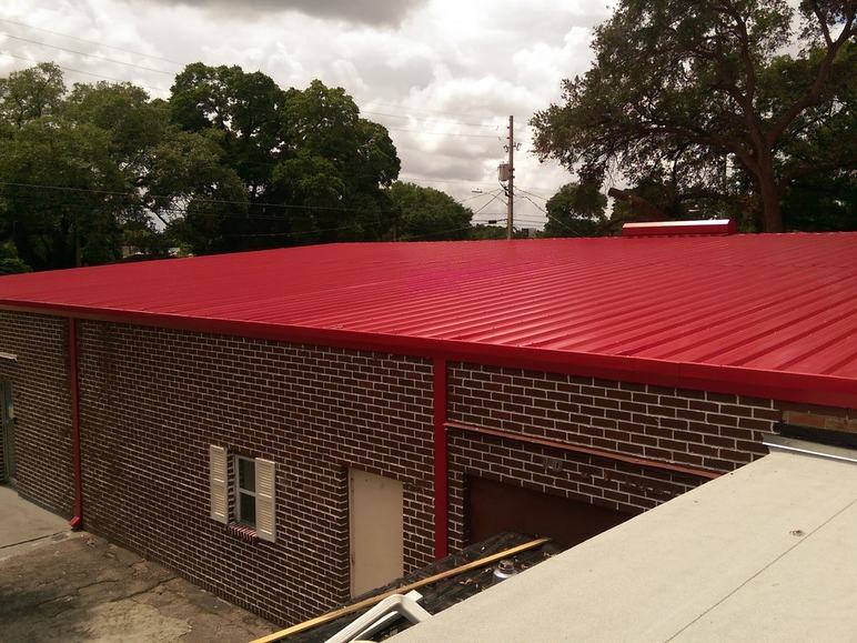Finished red metal roof section after installation.