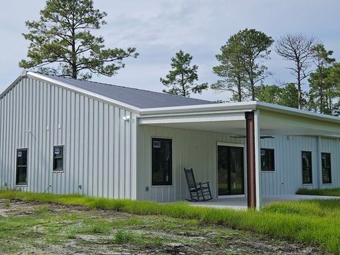 Barndominium new build exterior photo: the finished exterior of the completed barndominium, view 1 of 2