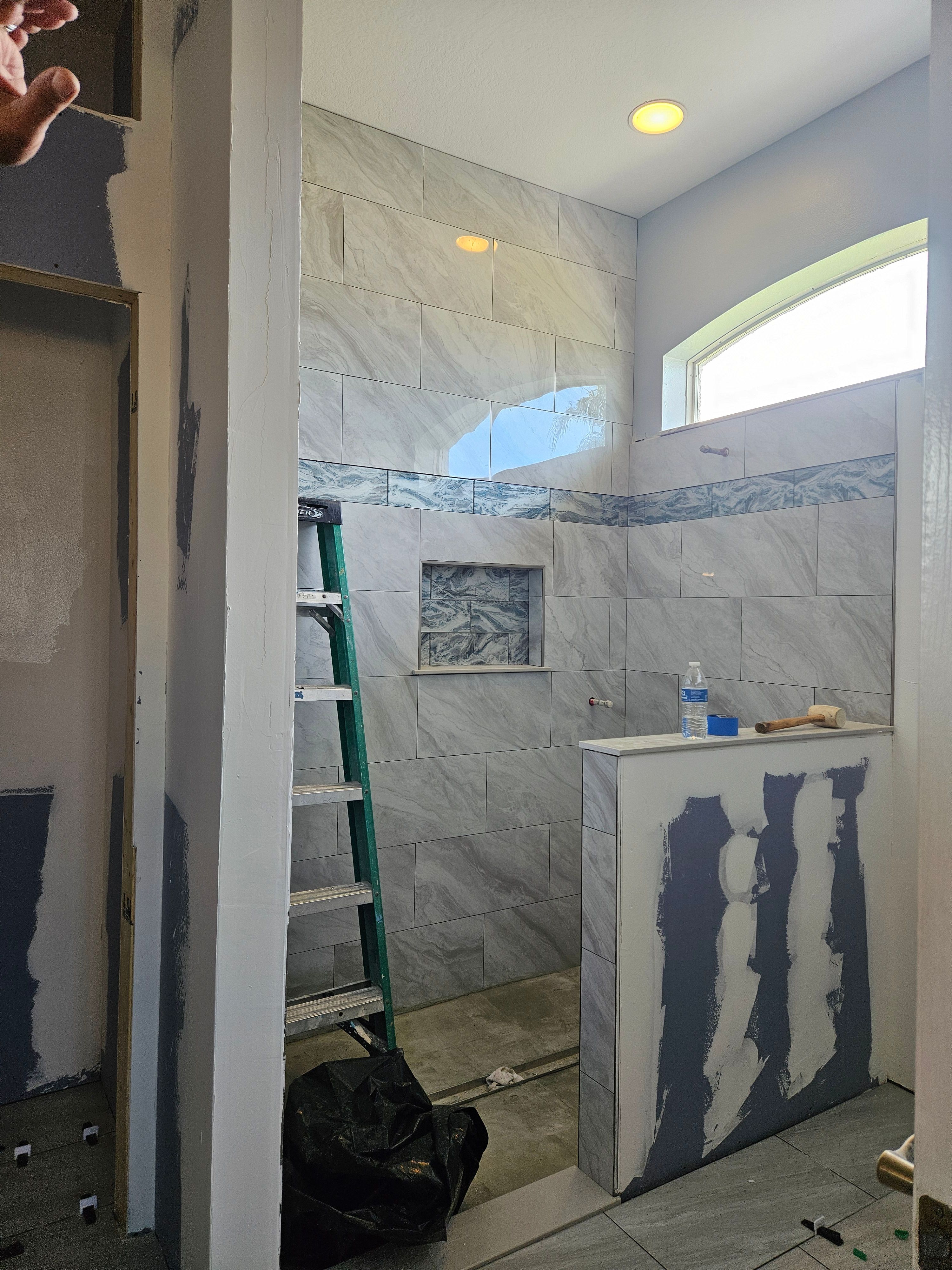 Process of framing out new shower with a custom half wall.