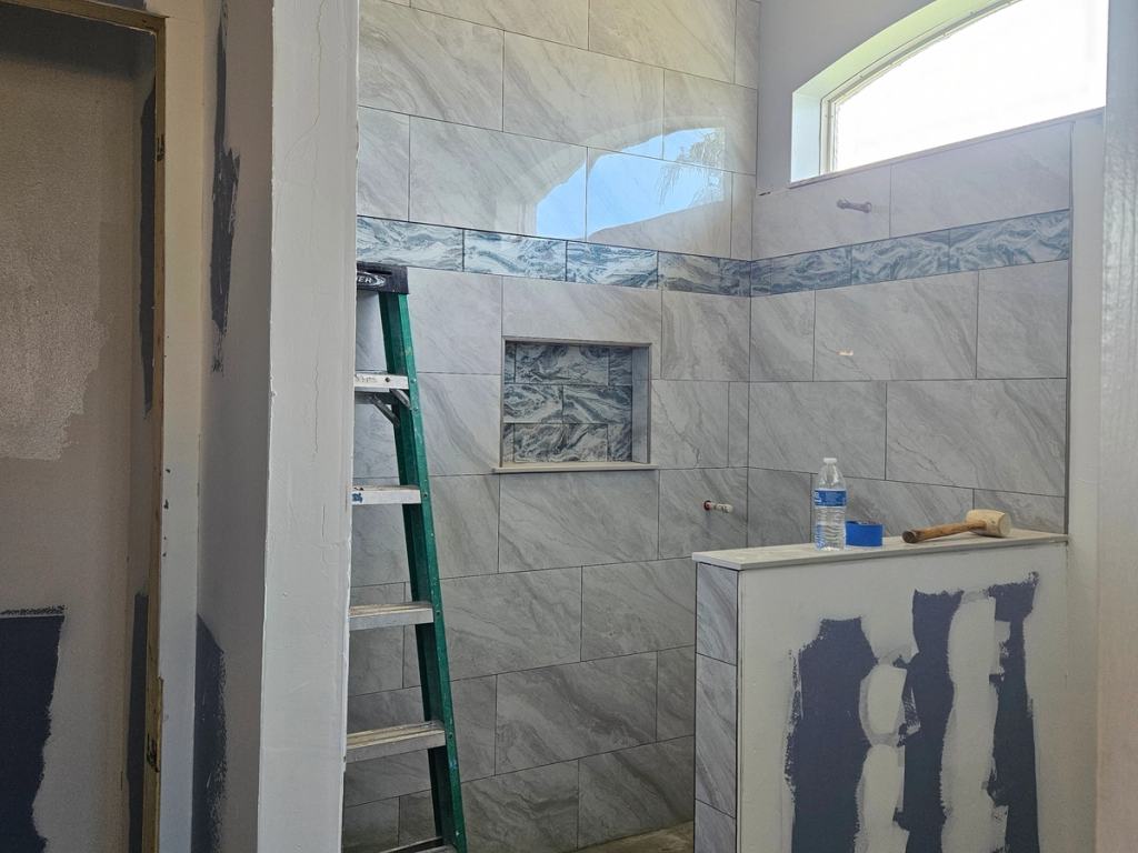 Process of framing out new shower with a custom half wall.