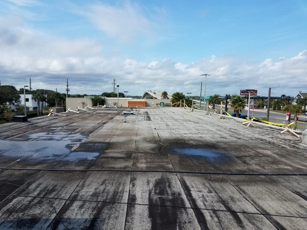 Silicone recovery system roof before photo: the existing flat roof surface as it appeared before the coating work