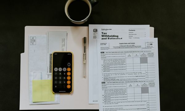 Paper forms, a phone and a pen on a folder, representing the business documents you prepare to register as a supplier on e-Katalog v6 in Indonesia