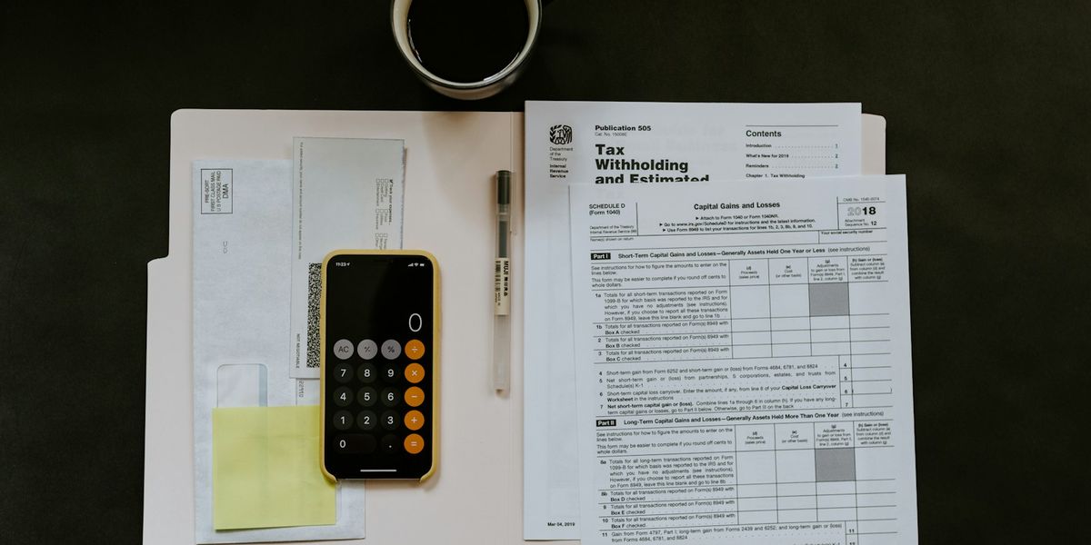 Paper forms, a phone and a pen on a folder, representing the business documents you prepare to register as a supplier on e-Katalog v6 in Indonesia