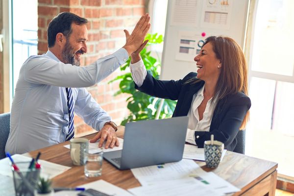 How much a company website costs in 2026 — a business team comparing vendor quotes and setting a website budget, working through the five factors that drive the price: page count, template versus custom design, features and integrations, content production, and annual maintenance