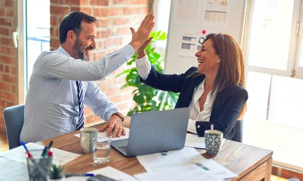 How much a company website costs in 2026 — a business team comparing vendor quotes and setting a website budget, working through the five factors that drive the price: page count, template versus custom design, features and integrations, content production, and annual maintenance