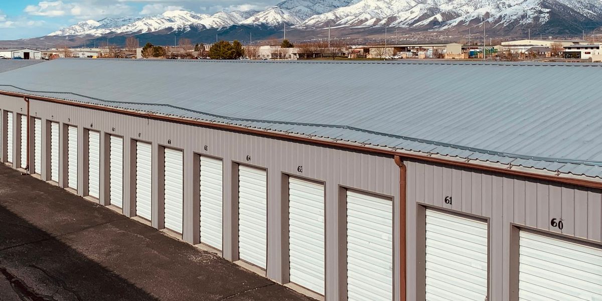 A long row of rented storage units with roll-up doors, an analogy for renting server capacity by the month