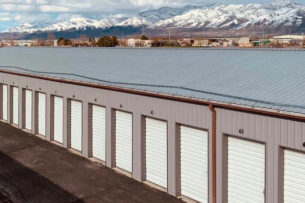 A long row of rented storage units with roll-up doors, an analogy for renting server capacity by the month