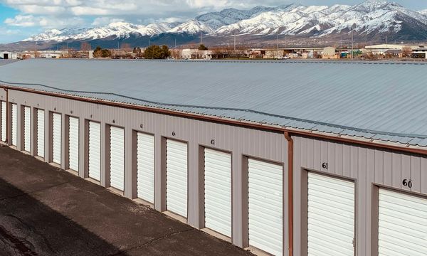 A long row of rented storage units with roll-up doors, an analogy for renting server capacity by the month